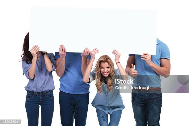 Smiling Woman Holding Banner With Her Friends Hiding Stock Photo - Download Image Now