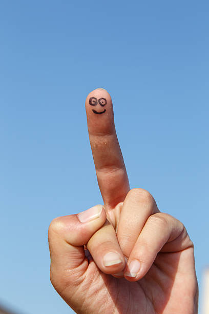 istock painted finger smile with sky at background 482034016