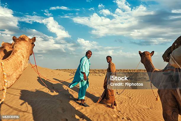 Two Cameleers Camel Drivers With Camels In Dunes Of Thar Stock Photo - Download Image Now