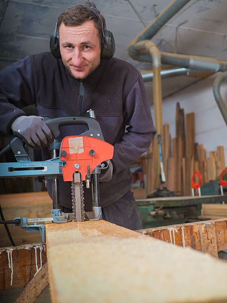 istock man with chain mortiser mill-cuts a wooden board 482038490