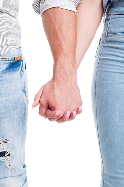 istock Vertical closeup of couple hands holding together 482038542