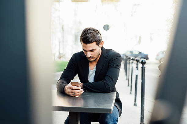 istock Young italian boy using a smartphone in a bar 482038642