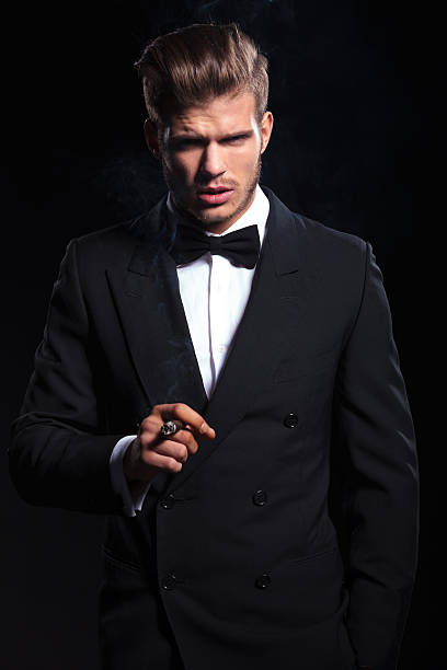 istock dramatic picture of an elegant man smoking a cigar 482038755