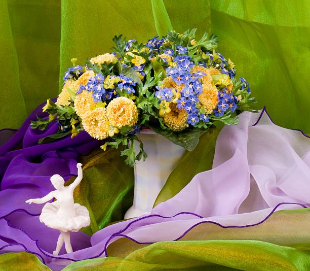istock Beautiful spring flowers in a glass vase and ballet-dancer 482038777