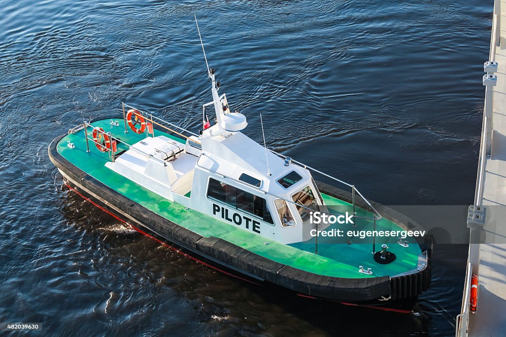 Small pilot boat with green deck and black hull Small pilot boat with green deck and black hull on a sea water 2015 Stock Photo