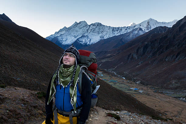 istock Mountaineer walking mountain trail above Lungde village, Nepal. 482044012