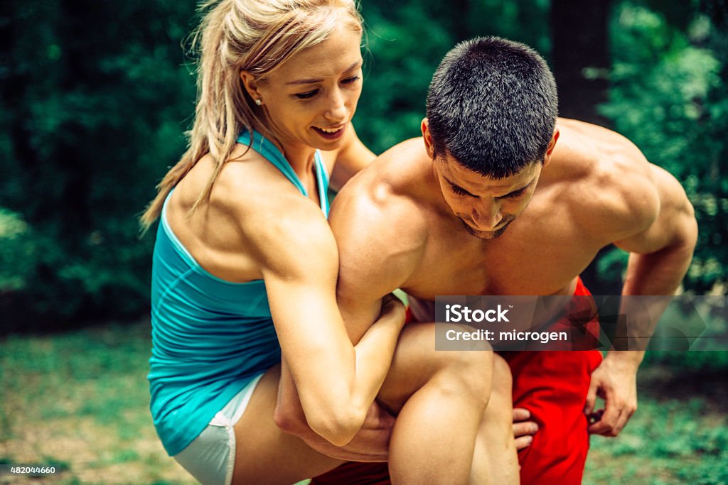 gym Couple Workout gym couple tied together in a lifting exercise 2015 Stock Photo