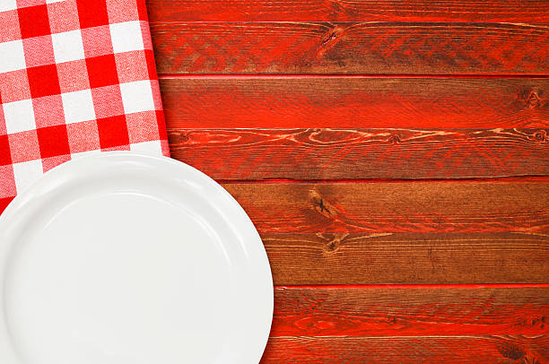 istock White Plate on Rustic Red Wood with Red Checked Napkin 482047538