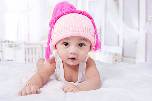 istock Attractive baby boy with hat on bed 482047638