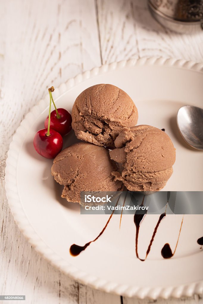 Chocolate ice cream Chocolate ice cream with cherry on a plate 2015 Stock Photo