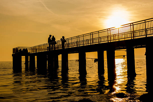 istock Peoples in pier at sunset 482050566