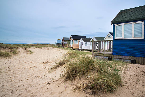 istock Lovely beach huts on sand dunes and beach landscape 482053332