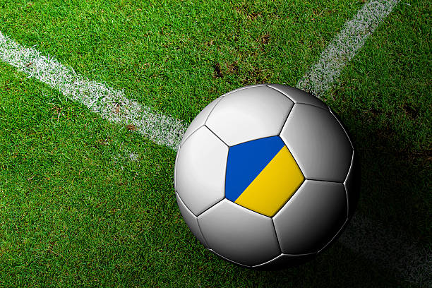 istock Ukraine Flag Pattern of a soccer ball in green grass 482055733