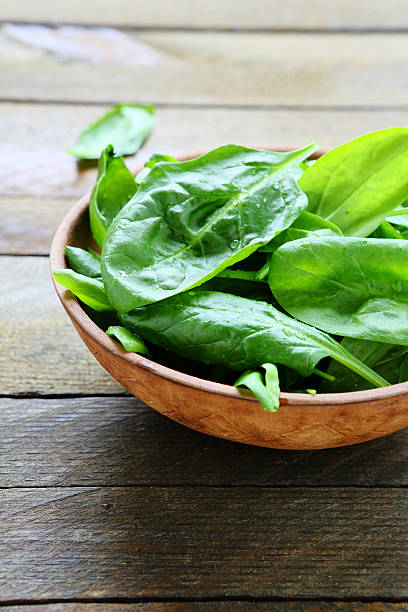 istock wet leaves of fresh spinach in a bowl 482058835