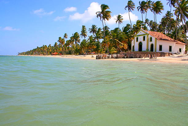 Paradise: deserted turquoise Palm Beach and baroque Church in Pernambuco, Northeastern Brazil