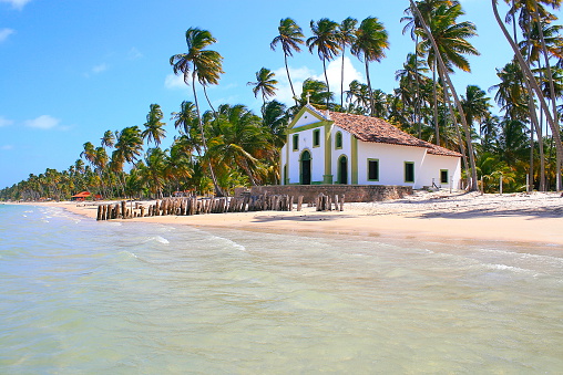 Paradise: deserted palm Beach and baroque Church in Pernambuco, Northeastern Brazil.