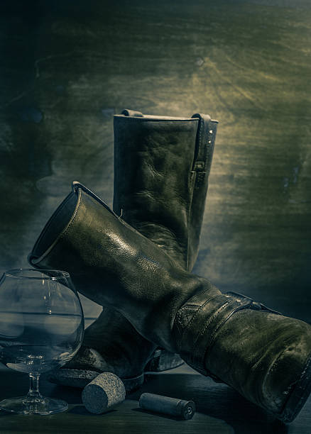 istock western still life with old cowboy boots, cartridge and brandy 482060901