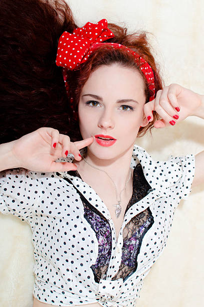 istock beautiful redhead pinup girl having fun relaxing 482063892