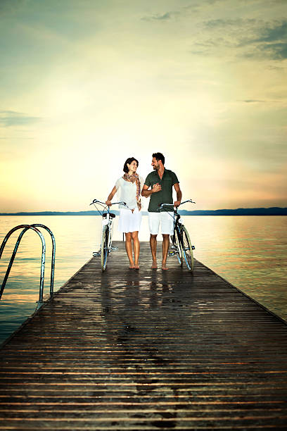 istock couple in love pushing bike on a boardwalk 482067066