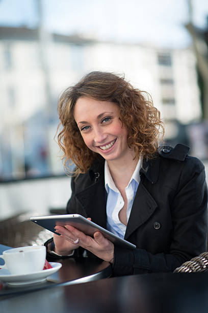 istock beautiful young woman outside playing with tablet computer 482067857
