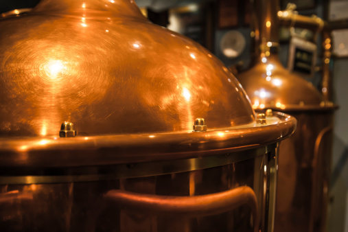 Large, copper container for brewing, many reflections of light.