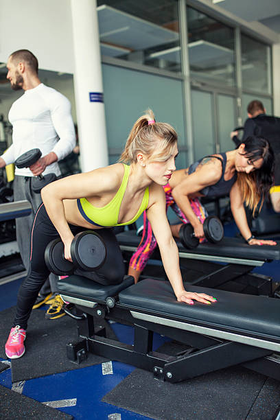 istock People Exercising With Dumbbells At Gym 482074229