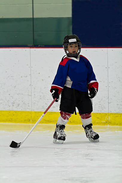 istock Young hockey player in an arena 482076859