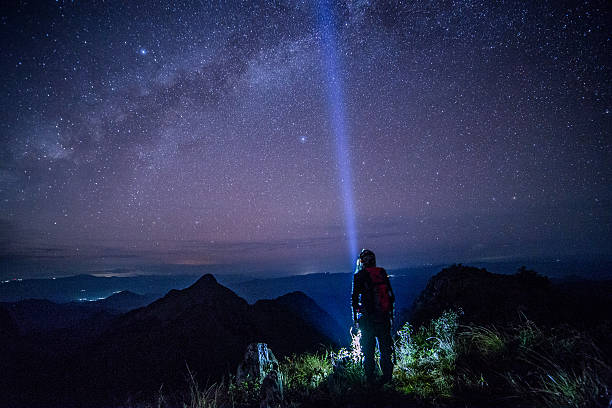 istock Young man Standing on Mountain with night sky. 482077201