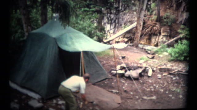 (1960's 8mm Vintage) Man Setting Up a Old Camping Tent
