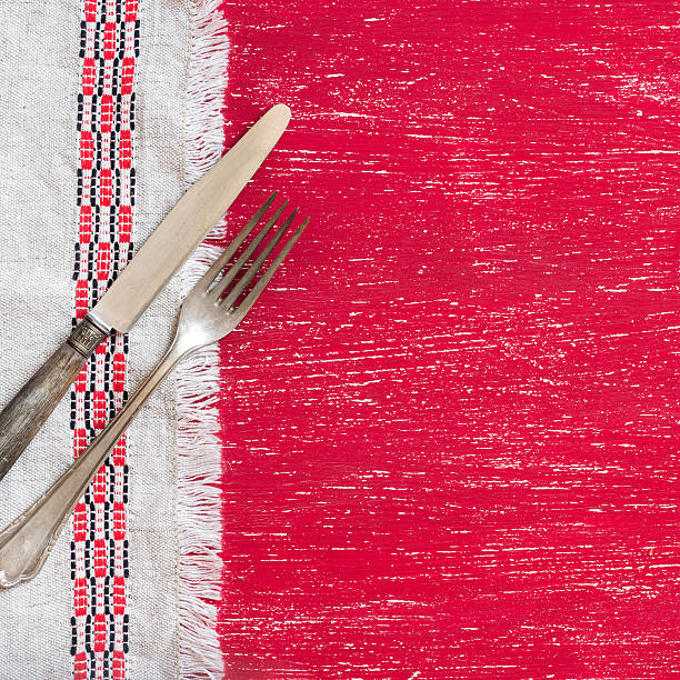 istock Vintage fork and knife on napkin on red wood 482080018