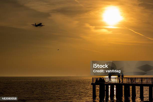 Peoples In Pier At Sunset Stock Photo - Download Image Now - 2015, Autumn, Backgrounds