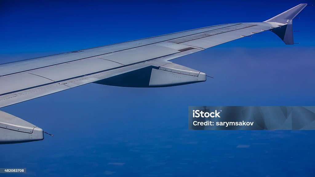 Aircraft wing on the clouds Aircraft wing on the clouds,flying background. In 16:9 format 16x9 Format Stock Photo