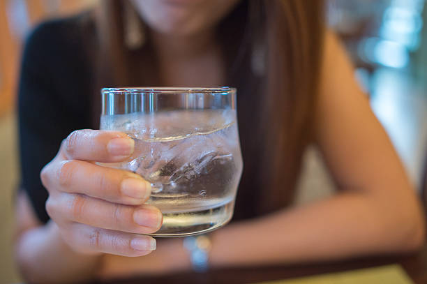 istock girl holding water glass 482084740