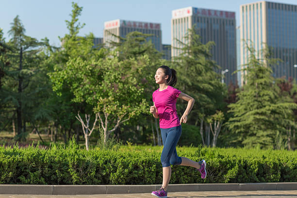 chinese woman running outdoors training for marathon run