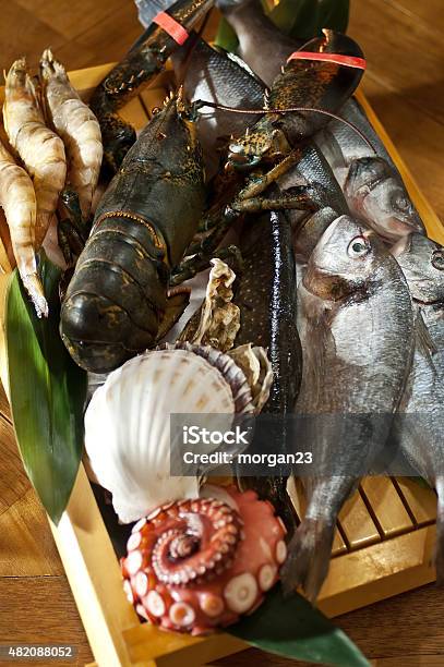 Fresh Catch Of Fish And Other Seafood On Wooden Board Stock Photo - Download Image Now