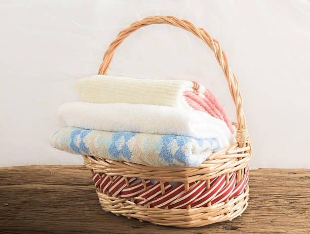 istock Bath towels of different colors in wicker basket 482091654