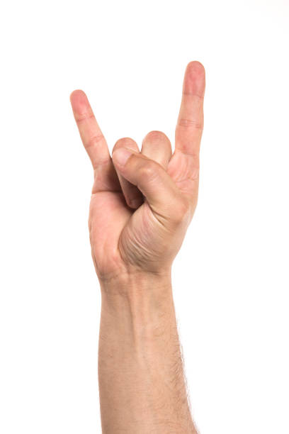 Man in Wristband making Rock & Roll Hand Symbol - Stock Image
