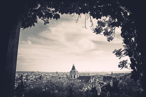 View on Saint Nicholas's Cathedral (Prague, Czech Republic) from garden pavilion. Black and white photo.