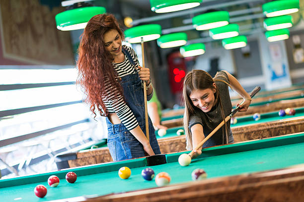 istock Two girls friends playing pool 482095860