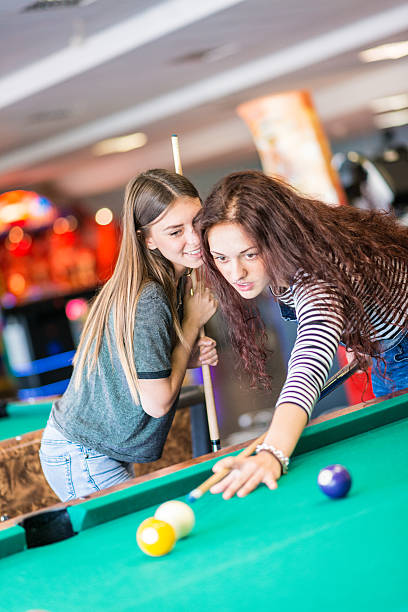 istock Two girls friends playing pool 482095862