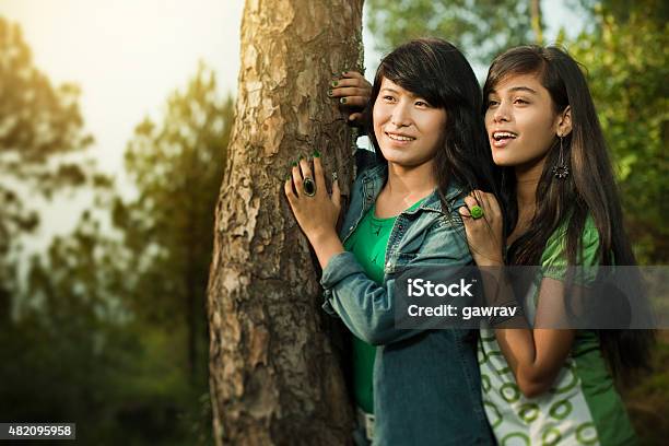 Two Happy Teenage Girls From Different Ethnicity Together In Nature Stock Photo - Download Image Now