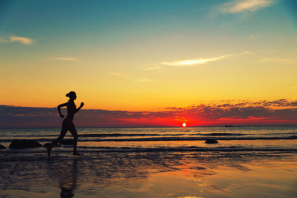 istock Female runing along the sea coast 482097681