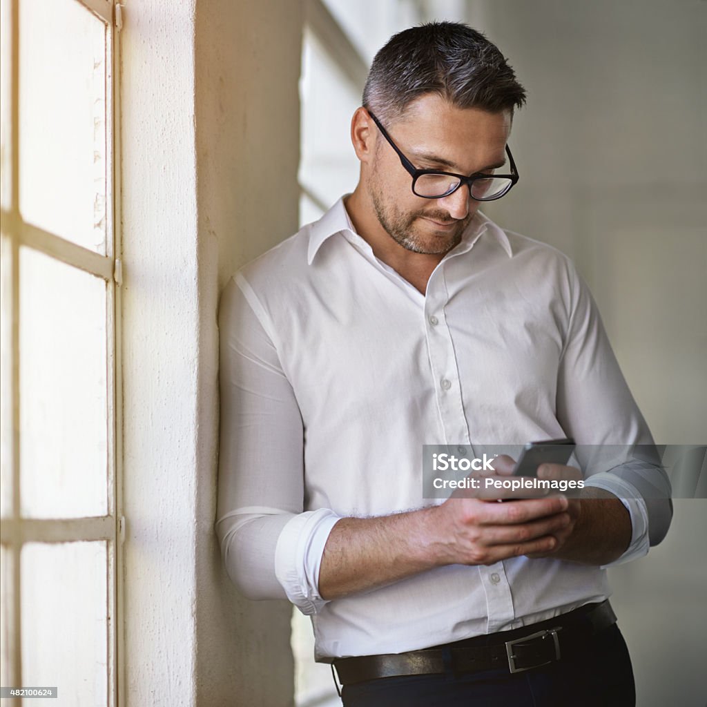 Giving prompt responses to his clients' texts Cropped shot of a businessman sending a text in his officehttp://195.154.178.81/DATA/i_collage/pi/shoots/805350.jpg 2015 Stock Photo