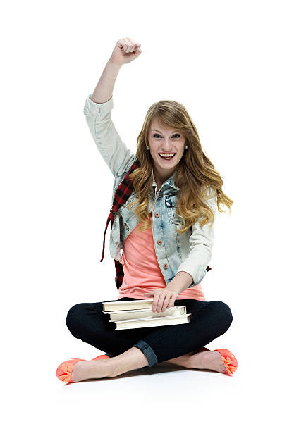 istock Cheerful student sitting on floor with hand raised 482101341