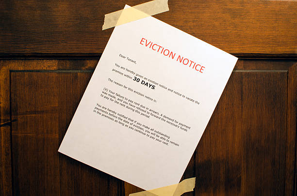 Eviction Notice An eviction notice taped to a door. information sign photos stock pictures, royalty-free photos & images