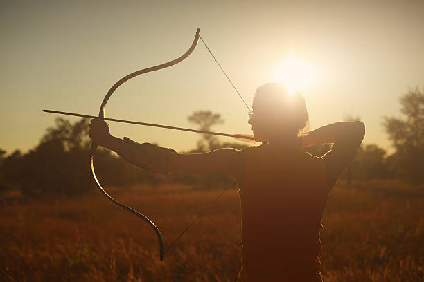 istock Female archer in the field at sunset 482101828