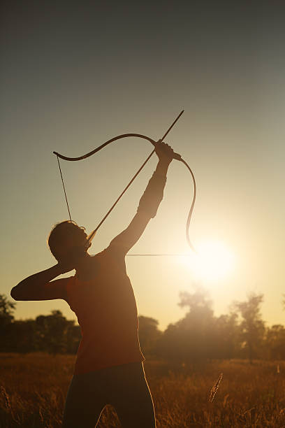 istock Female archer in the field at sunset 482101868