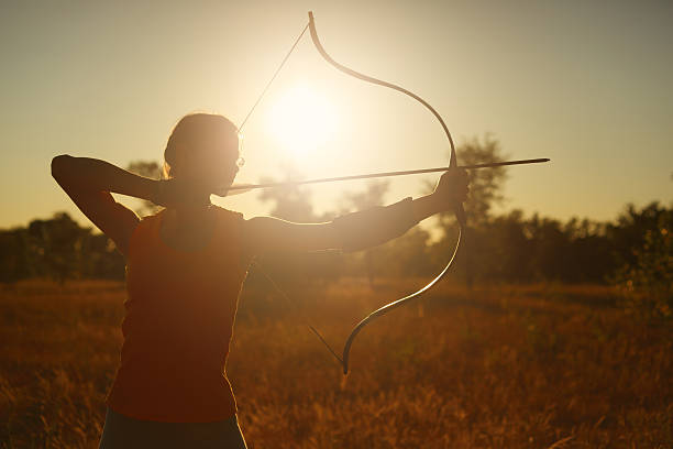 istock Female archer in the field at sunset 482101964