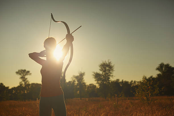 istock Female archer in the field at sunset 482101976