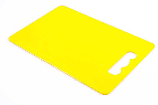istock Yellow plastic cutting board on isolated white background 482104173
